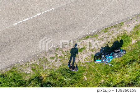 Top Down View of Custom Motorcycle and Biker Standing on Road 138860159