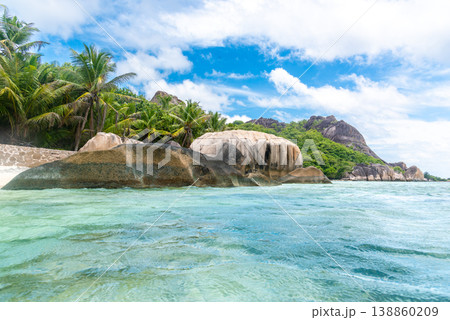 Tropical beach with granite rocks seen from the water 138860209