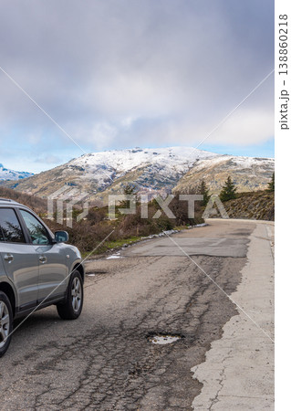 Rear View of 4x4 SUV Parked on Mountain Road with Snowy Mountains in Winter Rear View of 4x4 SUV Parked on Mountain Road with Snowy Mountains in Winter 138860218