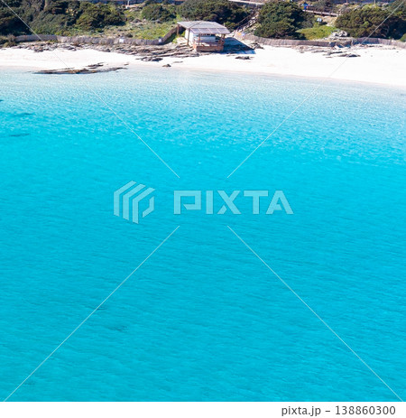 Aerial view of a wooden hut by the sea seen from the water 138860300