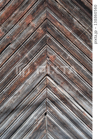 Rustic weathered wooden planks arranged in a chevron pattern with aged texture and peeling paint. Rustic weathered wooden planks arranged in a chevron pattern with aged texture and peeling paint. 138860560