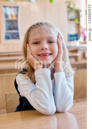 girl in the first grade, is sitting at the desk 138860815