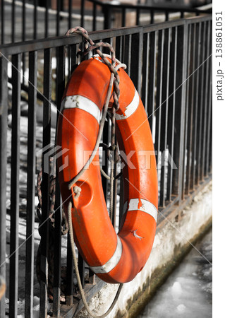 An outdoor ice fisherman rescue equipment on water . Vertical shot . An outdoor ice fisherman rescue equipment on water . Vertical shot . 138861051