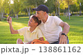 Happy father and son take selfie on smartphone in park. Happy dad and child enjoy family time outdoors. Parenting bond and joyful leisure on sunny day. Happy family. 138861162