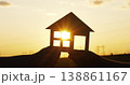 Silhouette of hands holding paper house at sunset. Sun rays shine through window, highlighting financial planning, home investment, and future opportunities for wealth and stability. 138861167