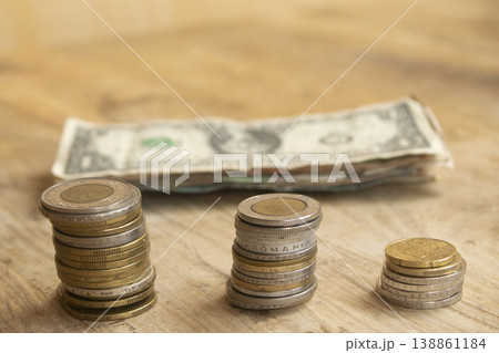 Stacks of international coins with dollar bill 138861184