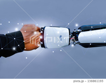 Human and robot fist bump against digital network background, representing future collaboration between man and artificial intelligence Human and robot fist bump against digital network background, representing future collaboration between man and artificial intelligence 138861193