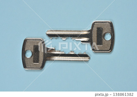 Two Metal Keys on Blue Background 138861382