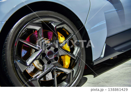 Detailed view of the carbon-ceramic braking system and multi-spoke alloy wheel on a grey sports car 138861429