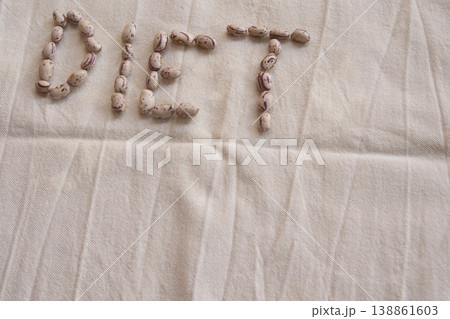 Diet word made of pinto beans on rustic textile background Diet word made of pinto beans on rustic textile background 138861603