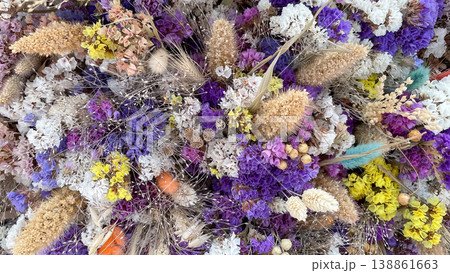 Full frame background of colorful dried Limonium flowers and Lagurus grass in a rustic floral pattern Full frame background of colorful dried Limonium flowers and Lagurus grass in a rustic floral pattern 138861663
