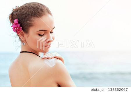Woman applying sunscreen creme on tanned shoulder. Skincare. Body Sun protection sun cream. Bikini woman smear moisturizing lotion on back. Woman applying sunscreen creme on tanned shoulder. Skincare. Body Sun protection sun cream. Bikini woman smear moisturizing lotion on back. 138862067