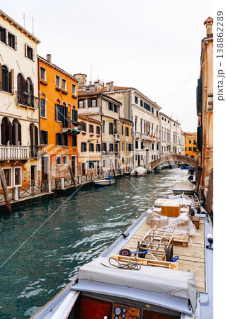 Venice waterways show boats and buildings along a canal in a busy city 138862289