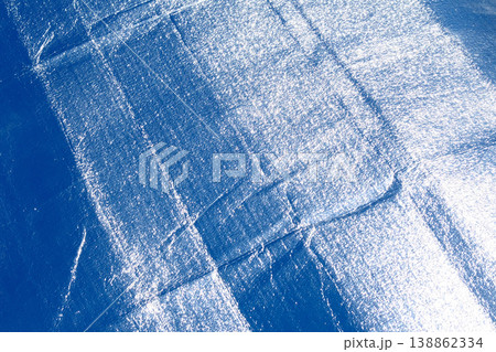 Silver foil foldable sun shade windshield reflector screen texture closeup with creases in car window protection Silver foil foldable sun shade windshield reflector screen texture closeup with creases in car window protection 138862334
