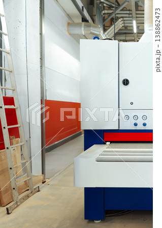 Machine in a factory setting with a ladder and a wall painted red Machine in a factory setting with a ladder and a wall painted red 138862473