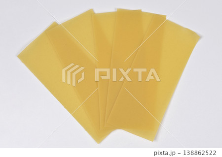 Dry Lasagna Pasta Sheets on White Background 138862522