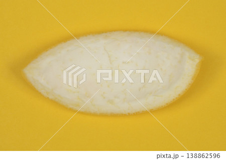 Inner grapefruit peel on yellow background Inner grapefruit peel on yellow background 138862596