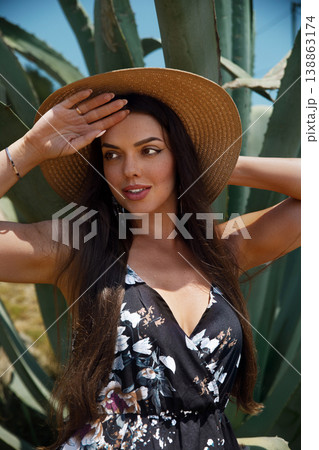 Beautiful Woman in Summer Dress and Straw Hat Outdoors. Travel and Vacation Fashion Concept 138863174