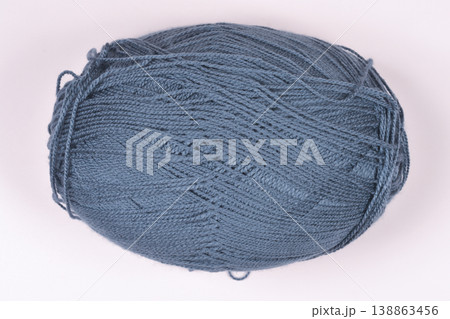Ball of grey wool yarn on beige background Ball of grey wool yarn on beige background 138863456