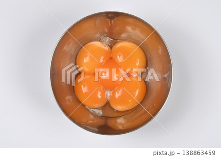 Five raw egg yolks in a stainless steel bowl Five raw egg yolks in a stainless steel bowl 138863459