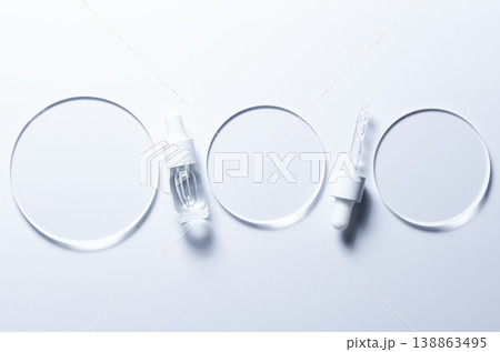 Glass circles on a blue background. A template for placing samples of cosmetics or medical products or food. Glass circles on a blue background. A template for placing samples of cosmetics or medical products or food. 138863495