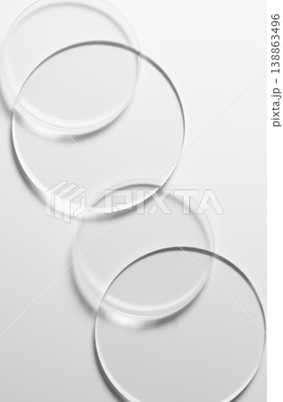 Glass circles on a white background. A template for placing samples of cosmetics or medical products or food. Glass circles on a white background. A template for placing samples of cosmetics or medical products or food. 138863496