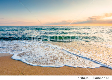 autumn vacation at the sea. beautiful seascape at sunrise. calm waves wash the sandy beach. image with fluffy clouds on the sky above horizon. perfect background for relaxation or ads placement autumn vacation at the sea. beautiful seascape at sunrise. calm waves wash the sandy beach. image with fluffy clouds on the sky above horizon. perfect background for relaxation or ads placement 138863648