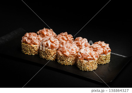 Delicious Fresh Salmon Sushi Rolls Presenting Exquisitely on a Black Background 138864327