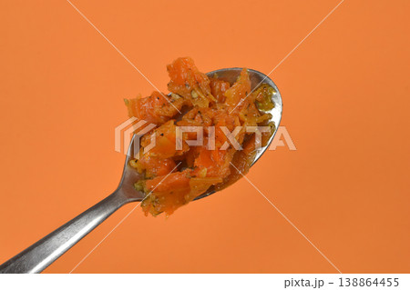 Marinated Carrot with Dill as Vegan Salmon on a Spoon over Orange Background Marinated Carrot with Dill as Vegan Salmon on a Spoon over Orange Background 138864455