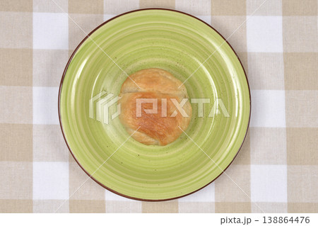Golden Brown Puff Pastry on a Green Plate Top View 138864476