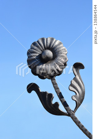 Wrought iron flower detail on a fence Wrought iron flower detail on a fence 138864544