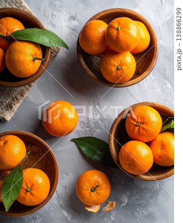 Bowls with sweet mandarins on grey background Bowls with sweet mandarins on grey background 138866299