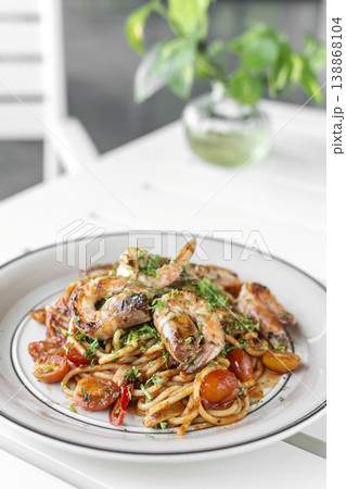 shrimp and tomato diavolo spicy spaghetti on white table at outdoor restaurant in italy shrimp and tomato diavolo spicy spaghetti on white table at outdoor restaurant in italy 138868104