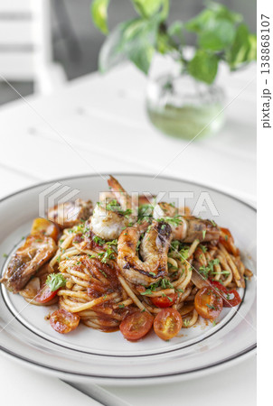 shrimp and tomato diavolo spicy spaghetti on white table at outdoor restaurant in italy shrimp and tomato diavolo spicy spaghetti on white table at outdoor restaurant in italy 138868107