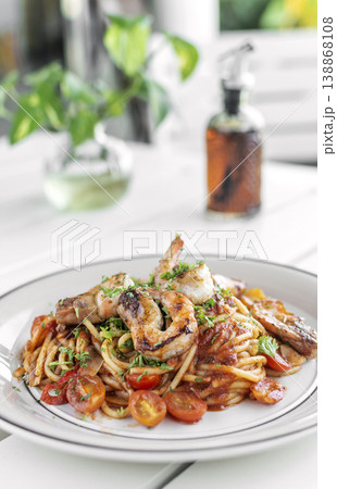 shrimp and tomato diavolo spicy spaghetti on white table at outdoor restaurant in italy shrimp and tomato diavolo spicy spaghetti on white table at outdoor restaurant in italy 138868108