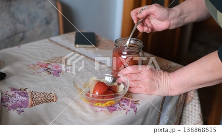 Opening jar pickled tomatoes winter preserves glass jar homemade food female hands closeup Opening jar pickled tomatoes winter preserves glass jar homemade food female hands closeup 138868615