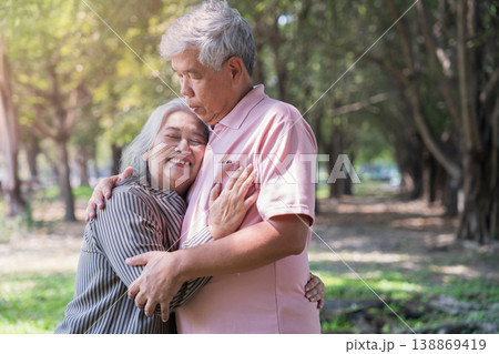 Embracing Moments: An elderly couple shares a tender embrace in a park, their faces radiating happiness and the warmth of a lifetime bond. Embracing Moments: An elderly couple shares a tender embrace in a park, their faces radiating happiness and the warmth of a lifetime bond. 138869419