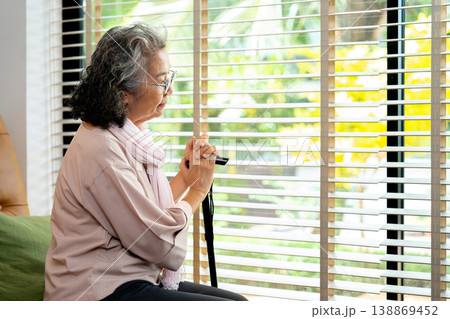 A senior citizen gazes out the window, reflecting on aging and retirement. The loneliness of Alzheimer and depression highlights the importance of compassionate elderly care and support A senior citizen gazes out the window, reflecting on aging and retirement. The loneliness of Alzheimer and depression highlights the importance of compassionate elderly care and support 138869452