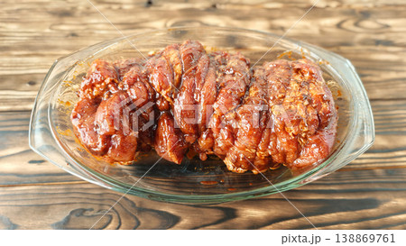 dish with sauce served in a glass bowl on a wooden table 138869761