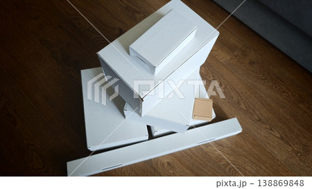 Boxes stacked on a wooden floor ready for packing and shipping items 138869848