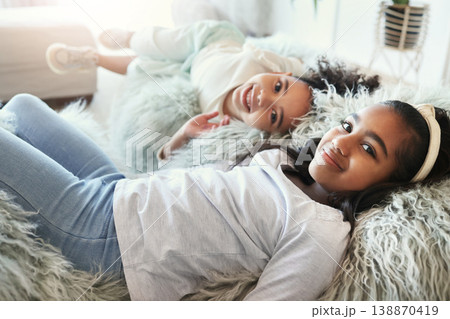 Relax, happy and portrait of children on the sofa for bonding, quality time and playing. Smile, calm and girl siblings on the couch to rest, play and enjoy company on the weekend in a family home Relax, happy and portrait of children on the sofa for bonding, quality time and playing. Smile, calm and girl siblings on the couch to rest, play and enjoy company on the weekend in a family home 138870419