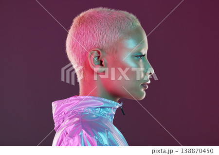 Holographic fashion, woman face and glow for hologram trend isolated on a studio background. Futuristic, vaporwave and art color jacket on cyberpunk model for retro cosmetics and makeup shine on skin Holographic fashion, woman face and glow for hologram trend isolated on a studio background. Futuristic, vaporwave and art color jacket on cyberpunk model for retro cosmetics and makeup shine on skin 138870450