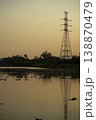The steel high tower for supply the electricity with group of birds in the wetland and clear sunset sky in background 138870479