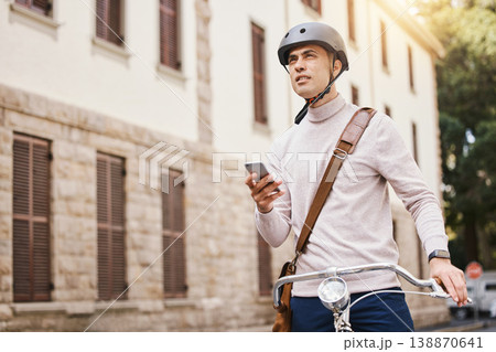 Student man, bike and city with phone, thinking and search for building in street for college in summer. Young guy, retro bicycle and smartphone with transport on campus, road and outdoor with vision 138870641