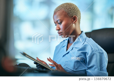 Security, working and black woman with tablet at a desk for communication, cctv app or building monitor. Digital, reading and an African safety officer typing on technology for a surveillance system 138870672