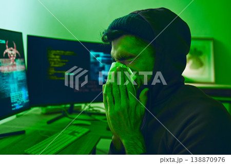Man, crime or sick hacker with virus in office for coding, online fraud or computer cybersecurity at night. Tissue, thief or ill programmer blowing nose or working on software data scam with fever 138870976