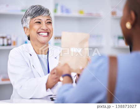 Happy woman, pharmacist and medication for patient prescription over the counter at the pharmacy. Female person, medical or healthcare professional giving customer pills or pharmaceutical package 138871027