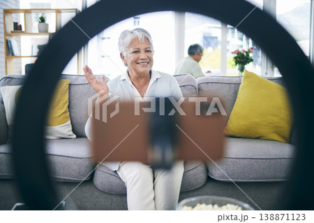 Mature woman, live streaming and vlog in home for social media, chat broadcast or wave to audience online. Happy lady, content creator and filming digital podcast in living room, phone and ring light Mature woman, live streaming and vlog in home for social media, chat broadcast or wave to audience online. Happy lady, content creator and filming digital podcast in living room, phone and ring light 138871123
