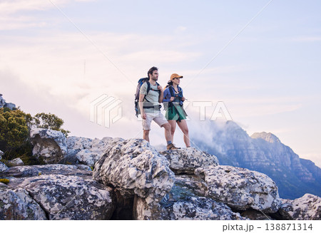 Mountain, hiking view and man with woman on peak for adventure in nature, landscape and travel. Outdoor trekking, couple on cliff and relax in scenic clouds for natural journey, walking and looking. Mountain, hiking view and man with woman on peak for adventure in nature, landscape and travel. Outdoor trekking, couple on cliff and relax in scenic clouds for natural journey, walking and looking. 138871314