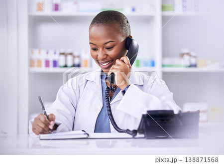 Black woman, phone call and pharmacist writing in notebook for Telehealth consultation at the pharmacy. Happy African female person, medical or healthcare professional talking on telephone at clinic Black woman, phone call and pharmacist writing in notebook for Telehealth consultation at the pharmacy. Happy African female person, medical or healthcare professional talking on telephone at clinic 138871568